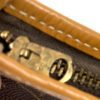 Close up of the brass zip pull and vachetta piping