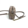 Side of the bag with the strap attached at the ring