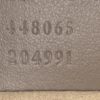 Serial numbers 448065 and 204991 embossed inside the bag