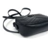 Bag resting on its side with the strap gathered above