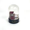 Snowglobe on its black base showing both miniature trunks