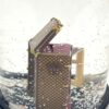 Detail of the monogram canvas trunk beside the red trunk