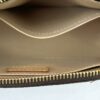 Interior opened showing the beige leather and inner tab