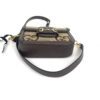 side view showing the top handle and leather trim