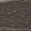 serial code embossed into the leather, dark on dark