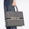 Book Tote carried by hand to show its scale against jeans
