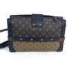 Back of the clutch in Reverse Monogram with gold studs