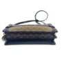 Side view of the clutch laid flat with the strap