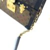 Angled view of the gold trunk lock and chain