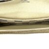 Interior opened showing the cream lining and zip pocket