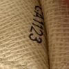 Date code CA1123 stamped inside the wallet