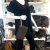 Pochette wristlet held by a mannequin in the boutique