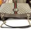 Top of the tote with the chain handles and tiger