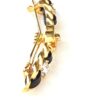 Clip stood upright showing the gold and black detail