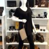 Pouch held by a mannequin in the boutique