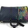 Front view with the strap laid across the checkerboard canvas