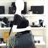 Duffle carried on the shoulder by a mannequin in the boutique