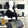 Mannequin holding the duffle at the side