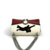 Bag standing with the silver chain draped in front