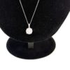 Close up of the pave cluster pendant and its halo