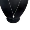 Close up of the pave cluster pendant on its fine chain