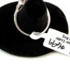 Ring laid on its side with the retail tag attached