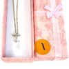 Gift box opened showing the necklace laid inside