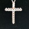 Detail of the cross and the chain against black velvet