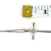 Cross measured against a tape to show the size