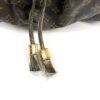 Close up of the two drawstring tassels with gold caps