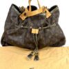 Bag shown resting on its Louis Vuitton dust bag