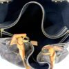 Interior zip pocket and drawstring cords seen from above