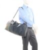 Studio campaign image of the duffle carried at the side