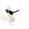 Sunglasses on a display head, seen in profile