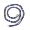 Necklace coiled in a spiral on a white background
