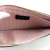 Pochette unzipped showing the pink lining and card slot