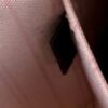 Close up of the leather tab with light marking on the pink lining