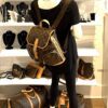Backpack worn on the shoulders by a mannequin in the boutique