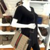 Messenger worn crossbody on a mannequin in the boutique