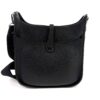 Bag with the canvas strap coiled beside it