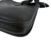 Side of the bag with the flap and strap attached