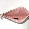 Open pochette from above showing the pink lining and tab
