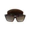 Frames resting in front of the brown suede Tom Ford case
