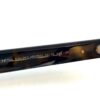 Close up of the T logo hinge on the tortoise temple