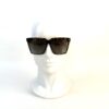 Sunglasses worn on a display head, seen at an angle