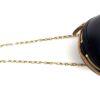Detail of the gold chain where it meets the bag