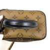 Leather top handle against the Reverse Monogram canvas