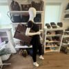 Mannequin holding the tote by its top handles