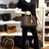 Mannequin holding the satchel at the front, seen head on