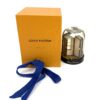 Snow globe with its orange Louis Vuitton box and ribbon
